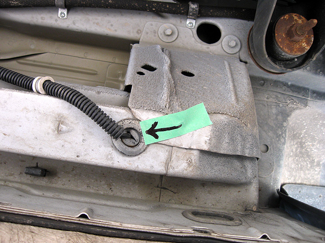 Cable entry beneath drivers door step (arrow points rearward)