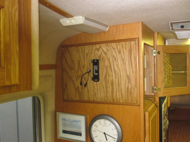 1/2 inch oak laminate with quarter round. I could not quite match the existing stain. The mount is a simple tilt-only inexpensive Sanus model VST15 purchased online. Tilt-only works fine for seating that is comfortable for viewing from the cabover