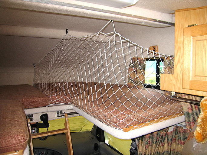 Attached is a picture of the netting we use for soft 'over the cab' storage when only one of us will be sleeping upstairs during our summer/fall travels